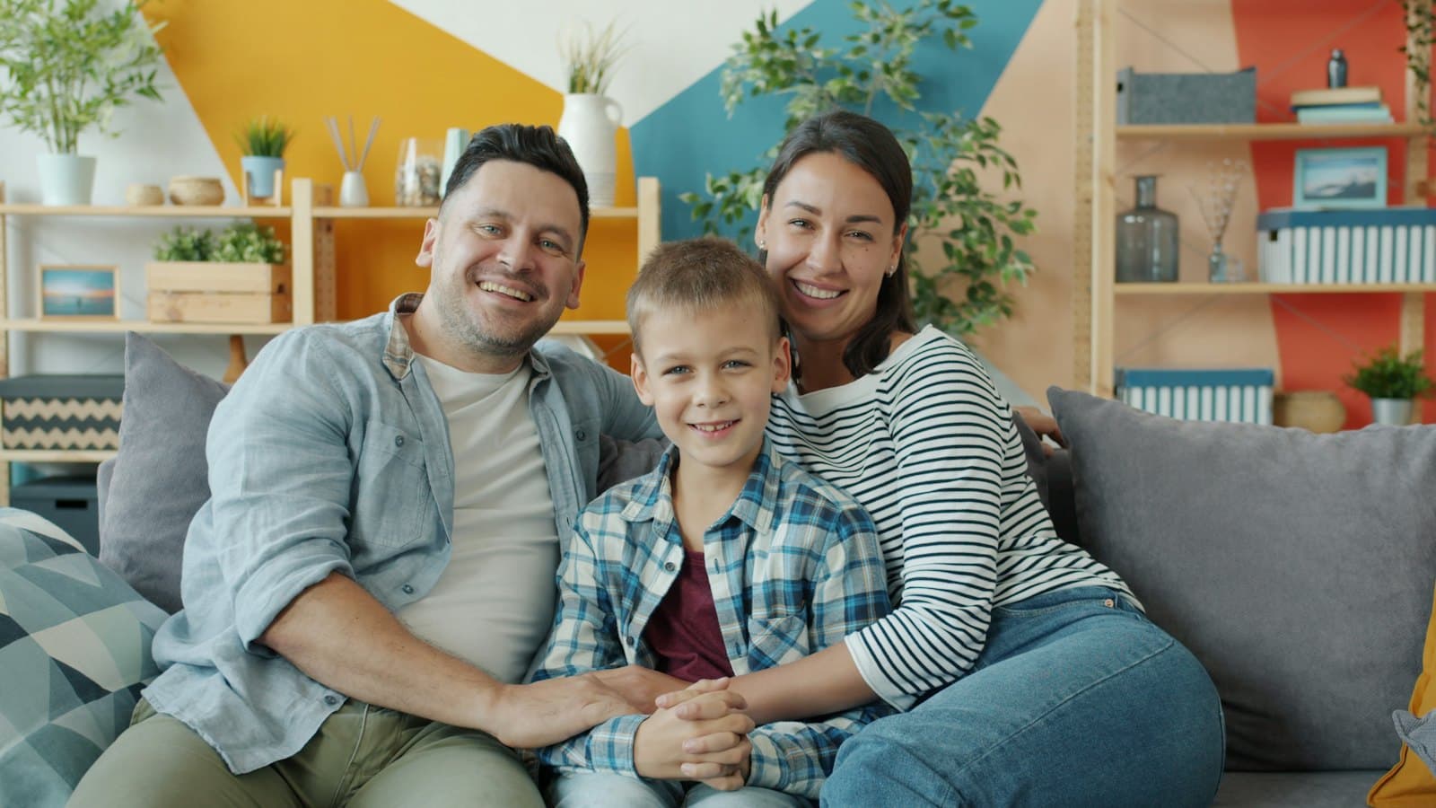 A happy family sitting on a couch at home